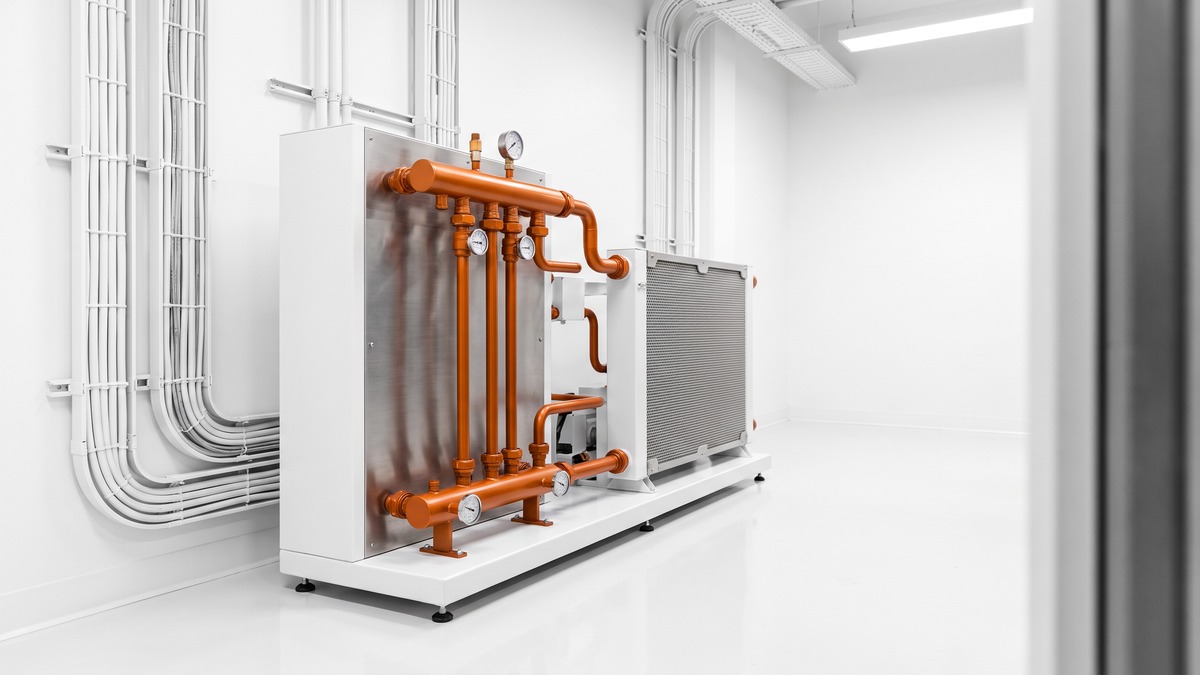 A coolant distribution unit and liquid-to-liquid heat exchanger in a data center mechanical room