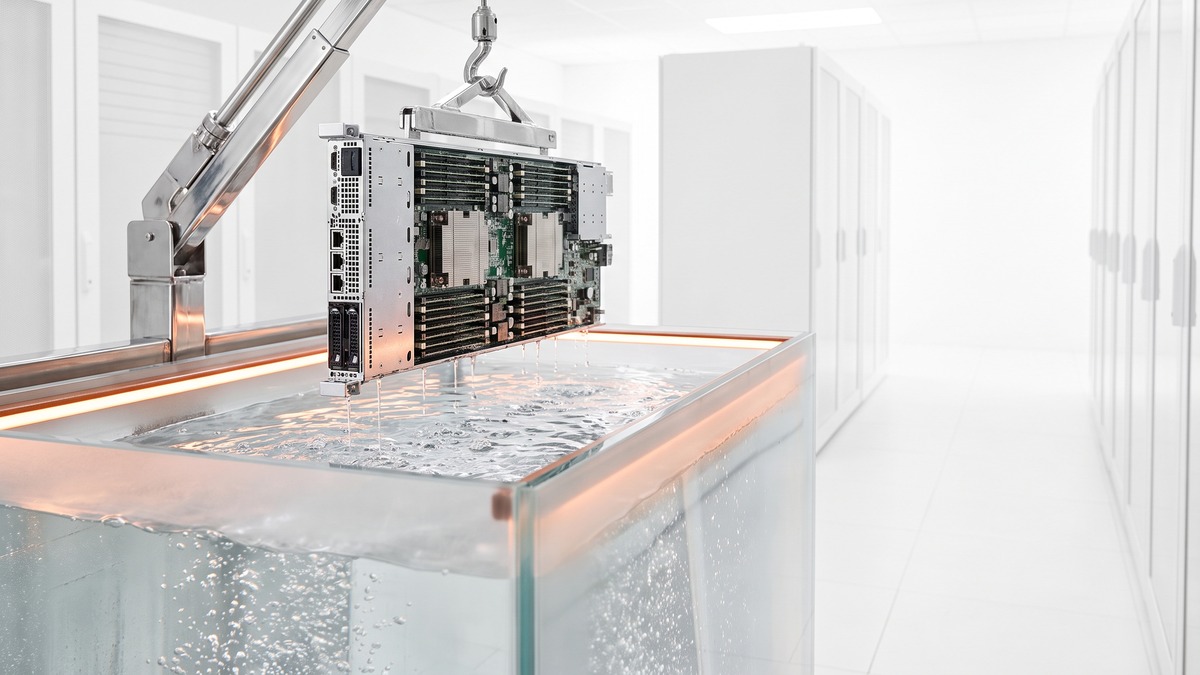 A server blade lifted by a hoist out of an immersion cooling tank, dripping dielectric fluid