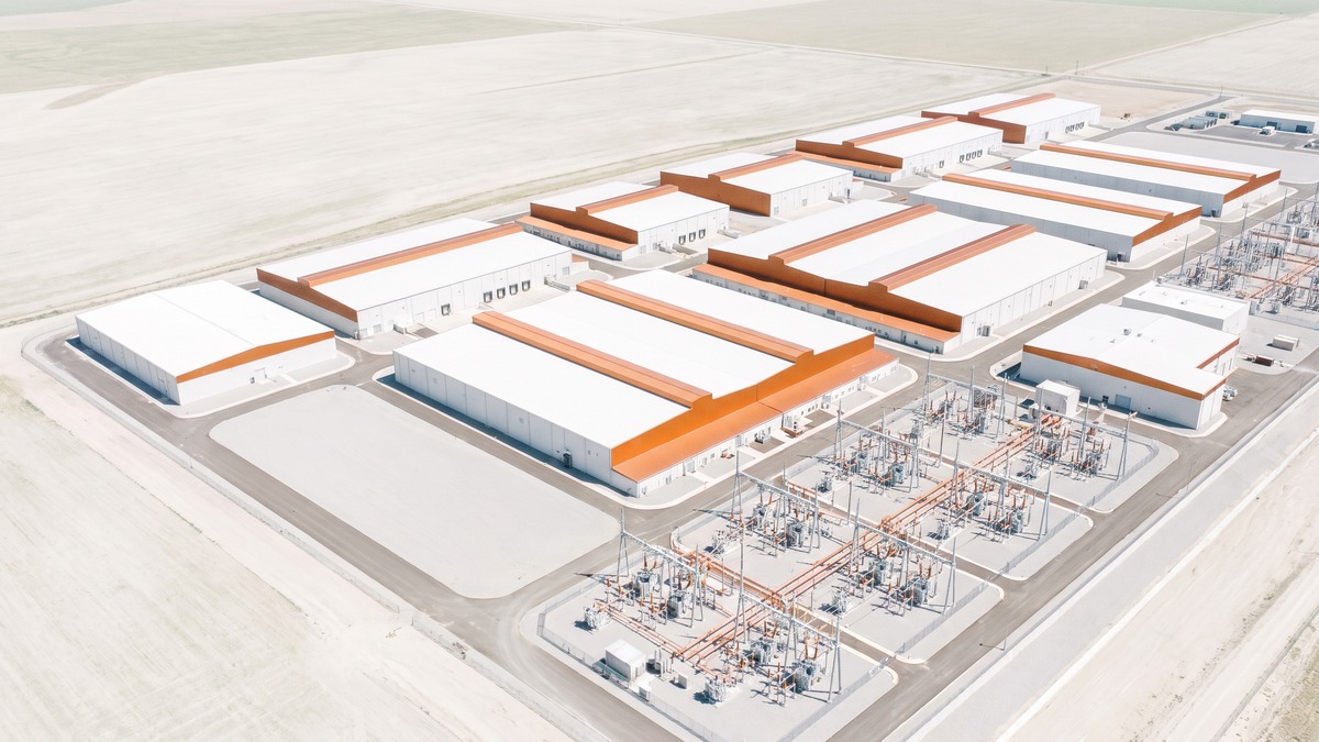 Aerial photograph of a hyperscale data center campus with visible electrical substation
